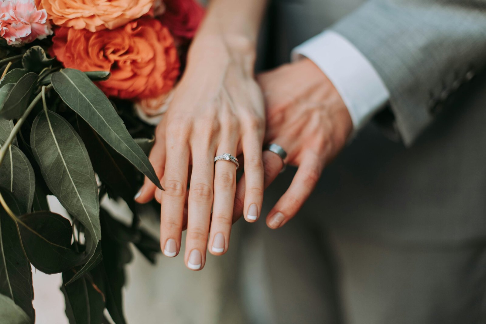 couple wearing silver-colored rings